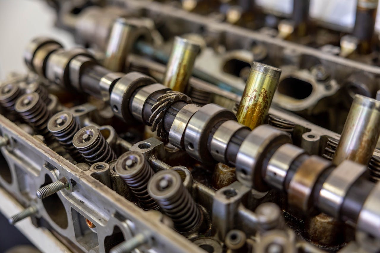 who-we-are Detailed view of camshaft inside an engine block illustrating mechanical engineering.